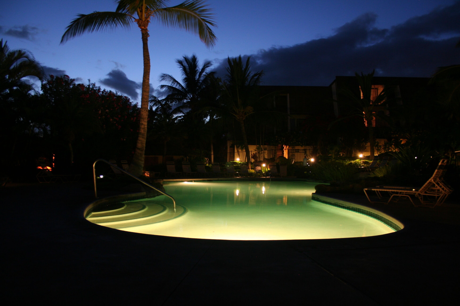 Nighttime view of the softly lit pool