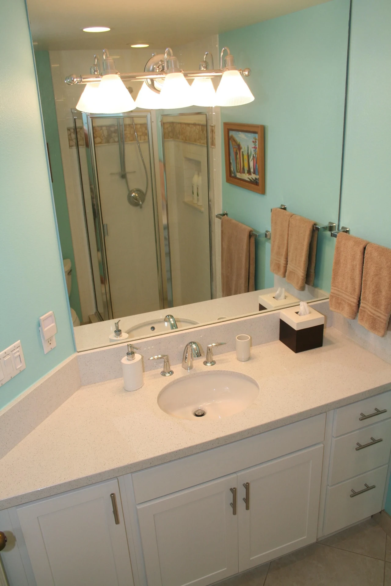Single vanity in the hall bathroom with shower reflected in the mirror