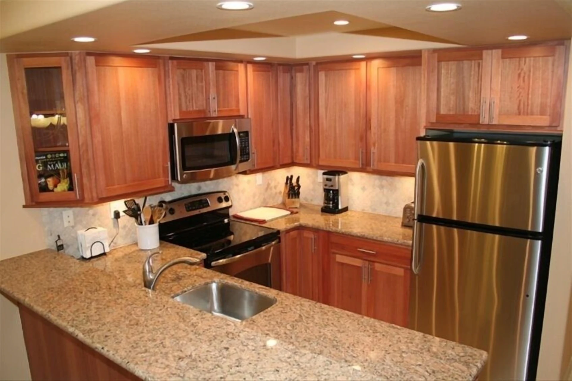 Kitchen with cherry cabinets, granite counters, and stainless steel appliances