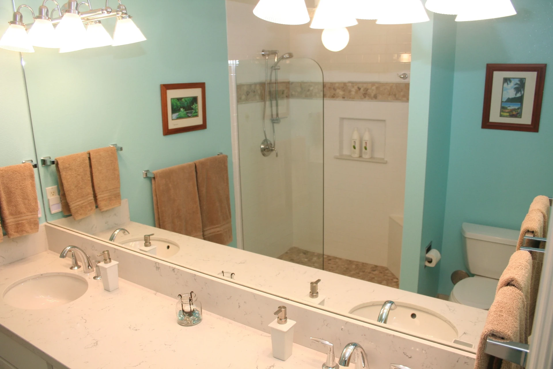 Long bathroom vanity, mirror, and glass shower