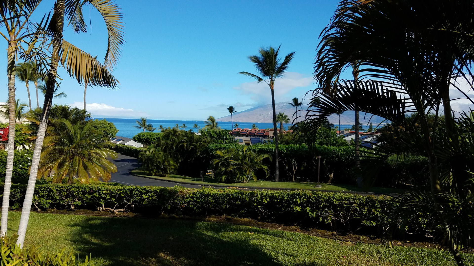 Palm-framed ocean view from Maui Kamaole J115 toward the West Maui Mountains