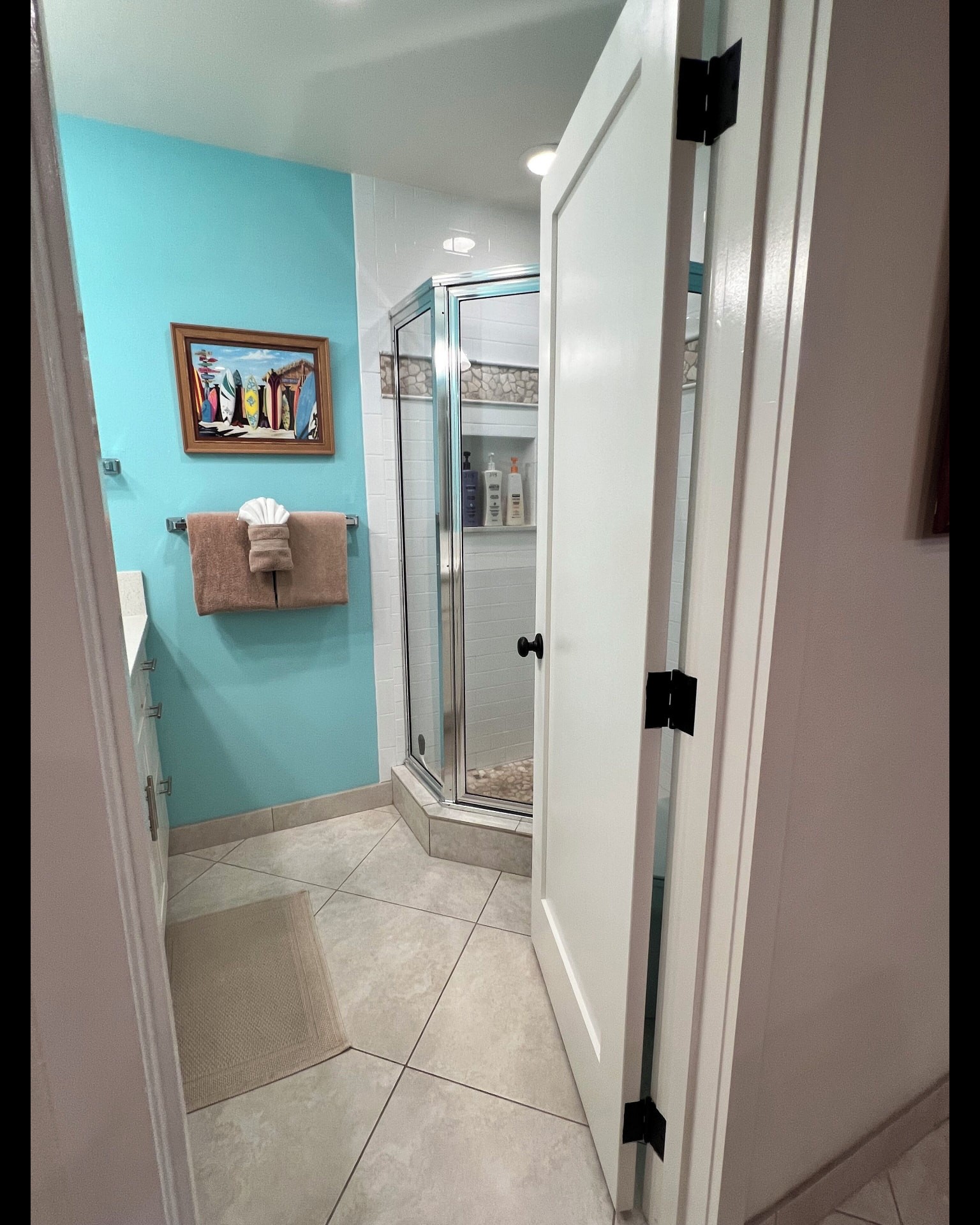 Hall bathroom viewed from the doorway with glass shower