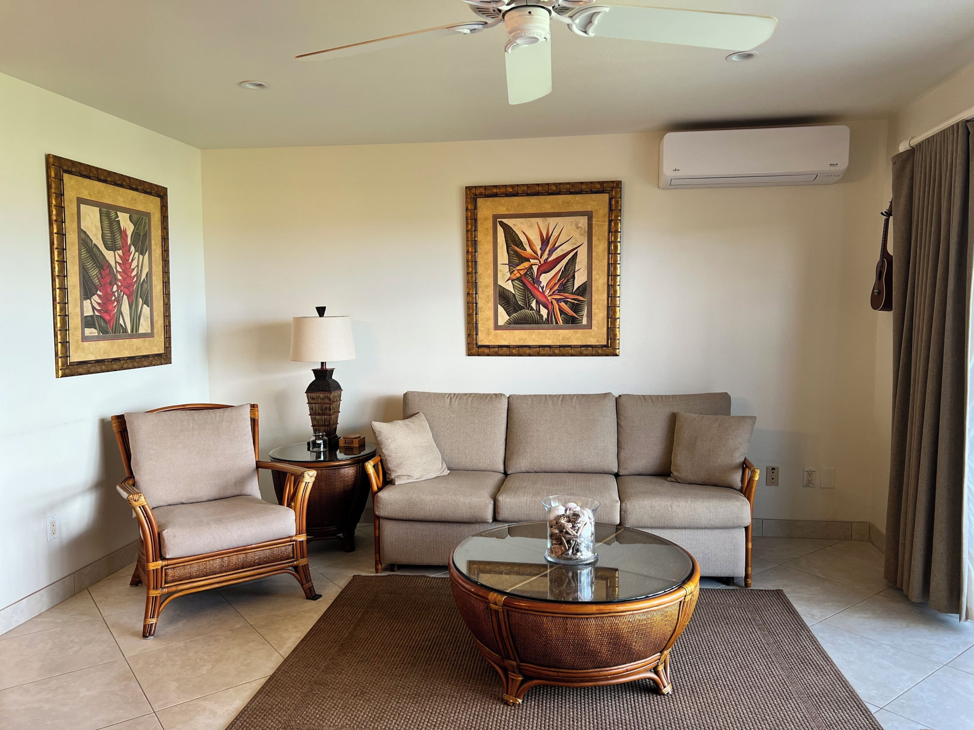 Living room with the split air conditioner above the sofa, seen from the entry