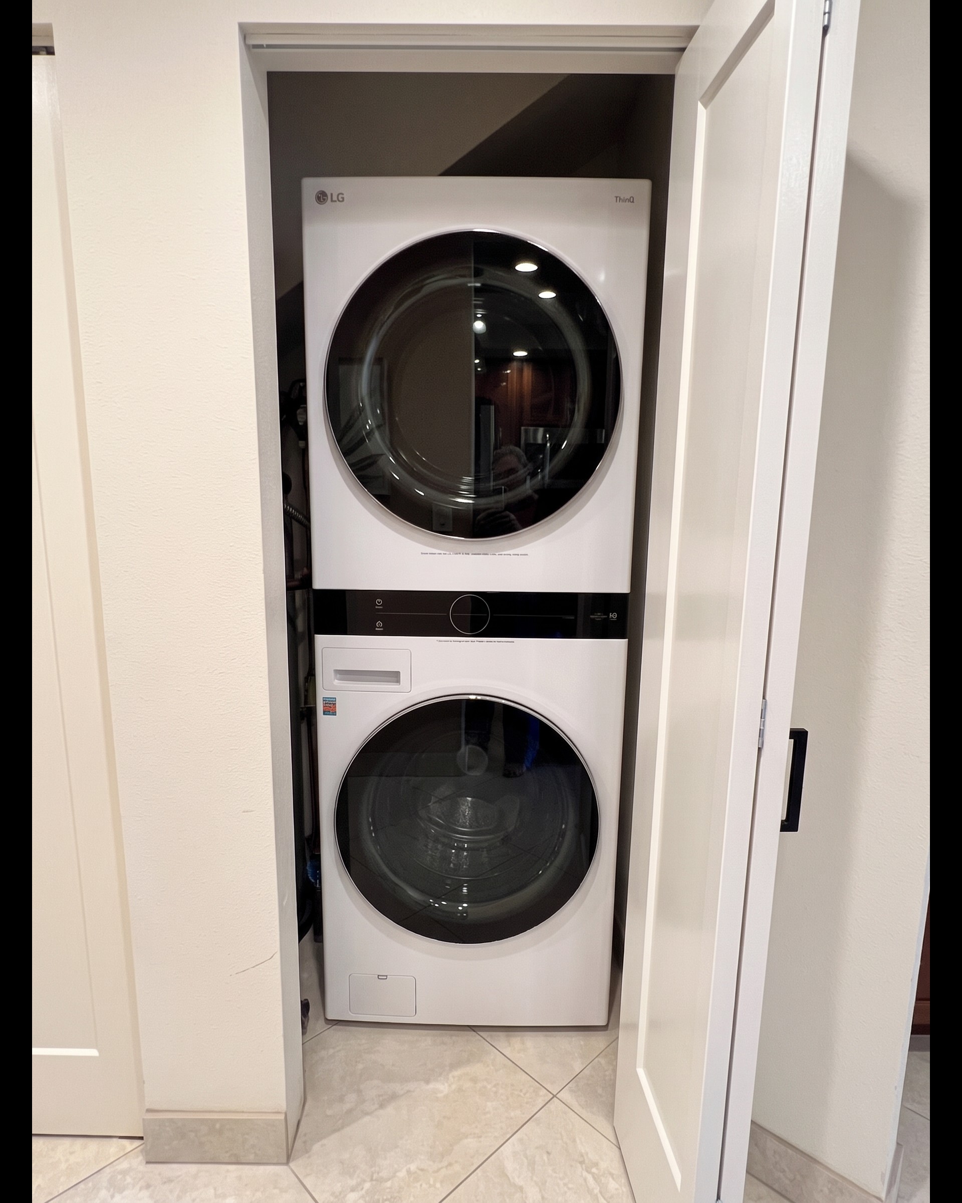 Stacked washer and dryer inside the condo